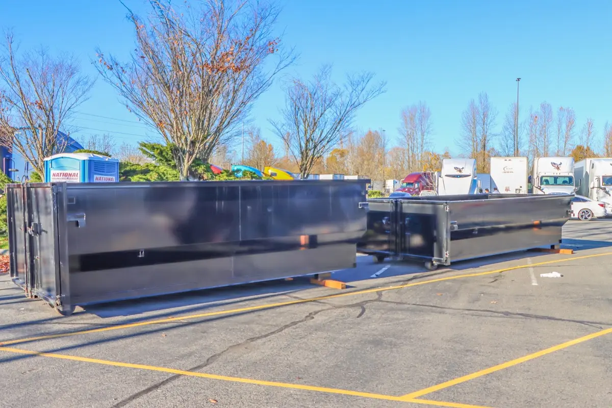 Professional dumpster rental service with roll-off container on residential driveway in Pikeville